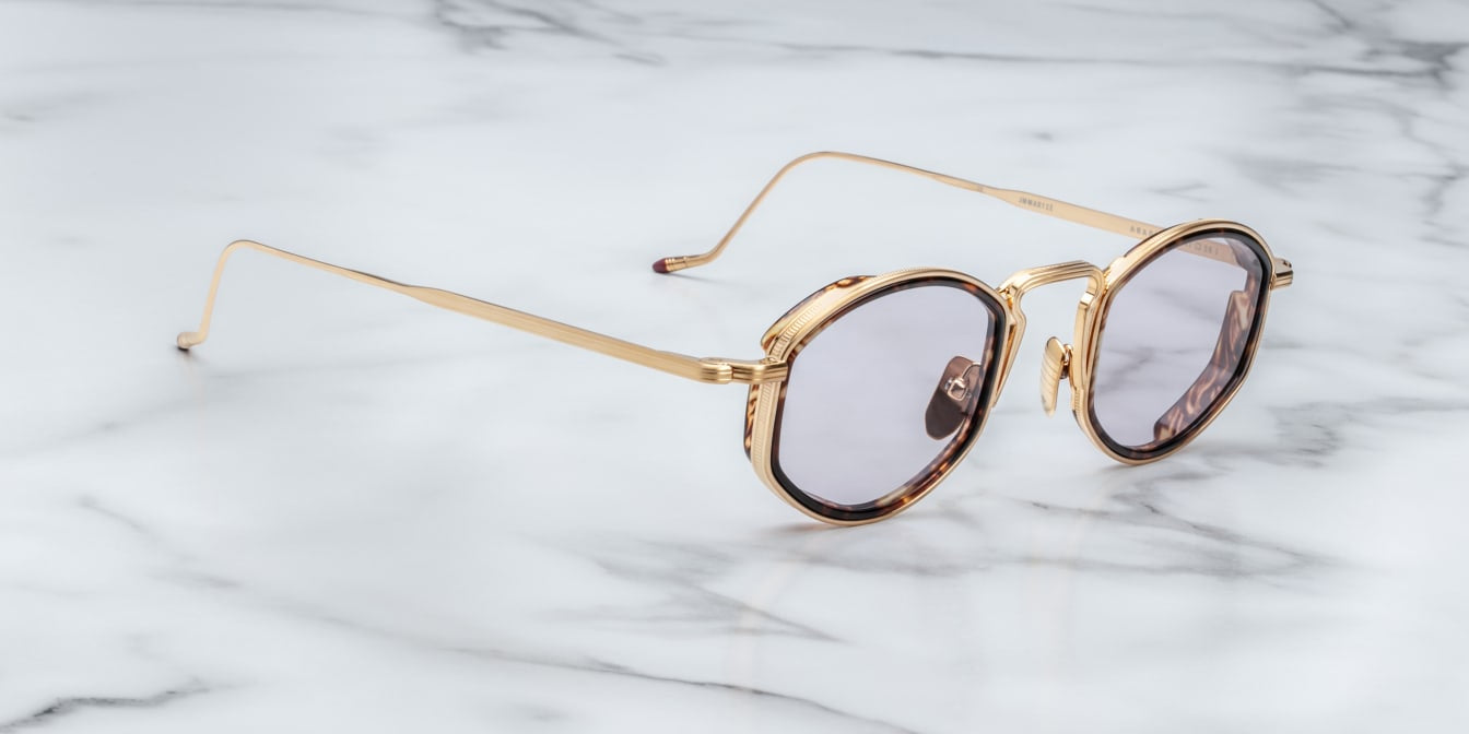 side view JMM Aragon oval shaped gold frames with innfer tortishell rim and key hold bridge