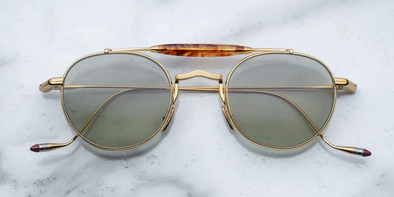 Gold metal aviator style sunglass with double bridge and acetate finish at the top
