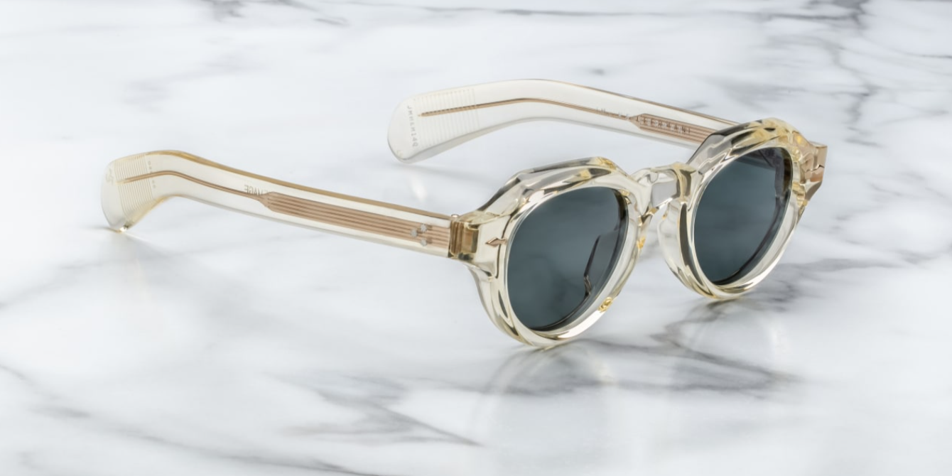 A pair of jacques marie mage frames with panto shape side on vie of the kellerman in a transparent champagne colour