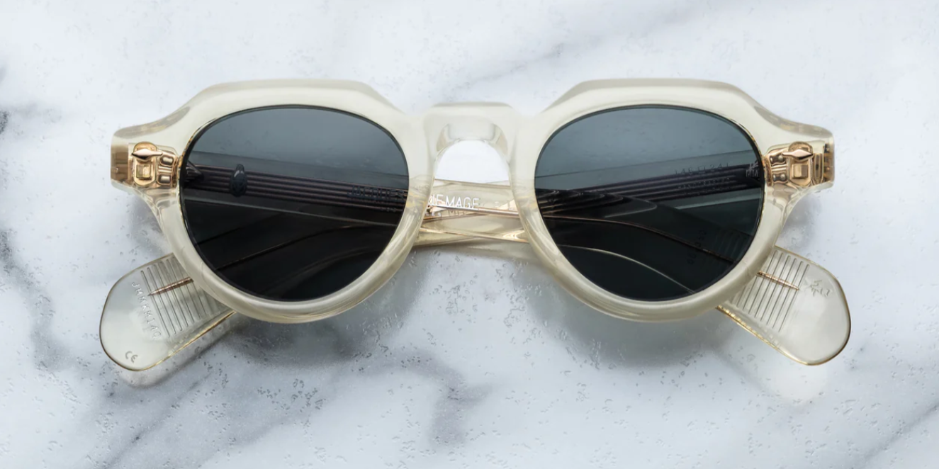 A pair of Jacques Marie Mage sunglasses with a modified Panto-shape, featuring a precious metal arrowhead front, spur-shaped rivets, and custom 7-barrel hinges.