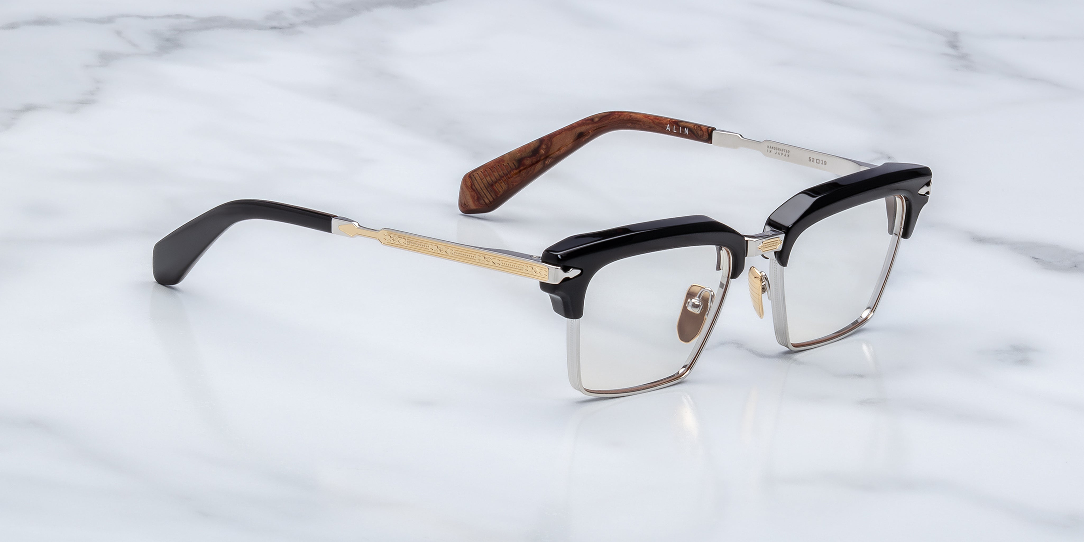 JMM alin noirx side view, black acetate top rim and ilver bottom rim. gold and silver temples 