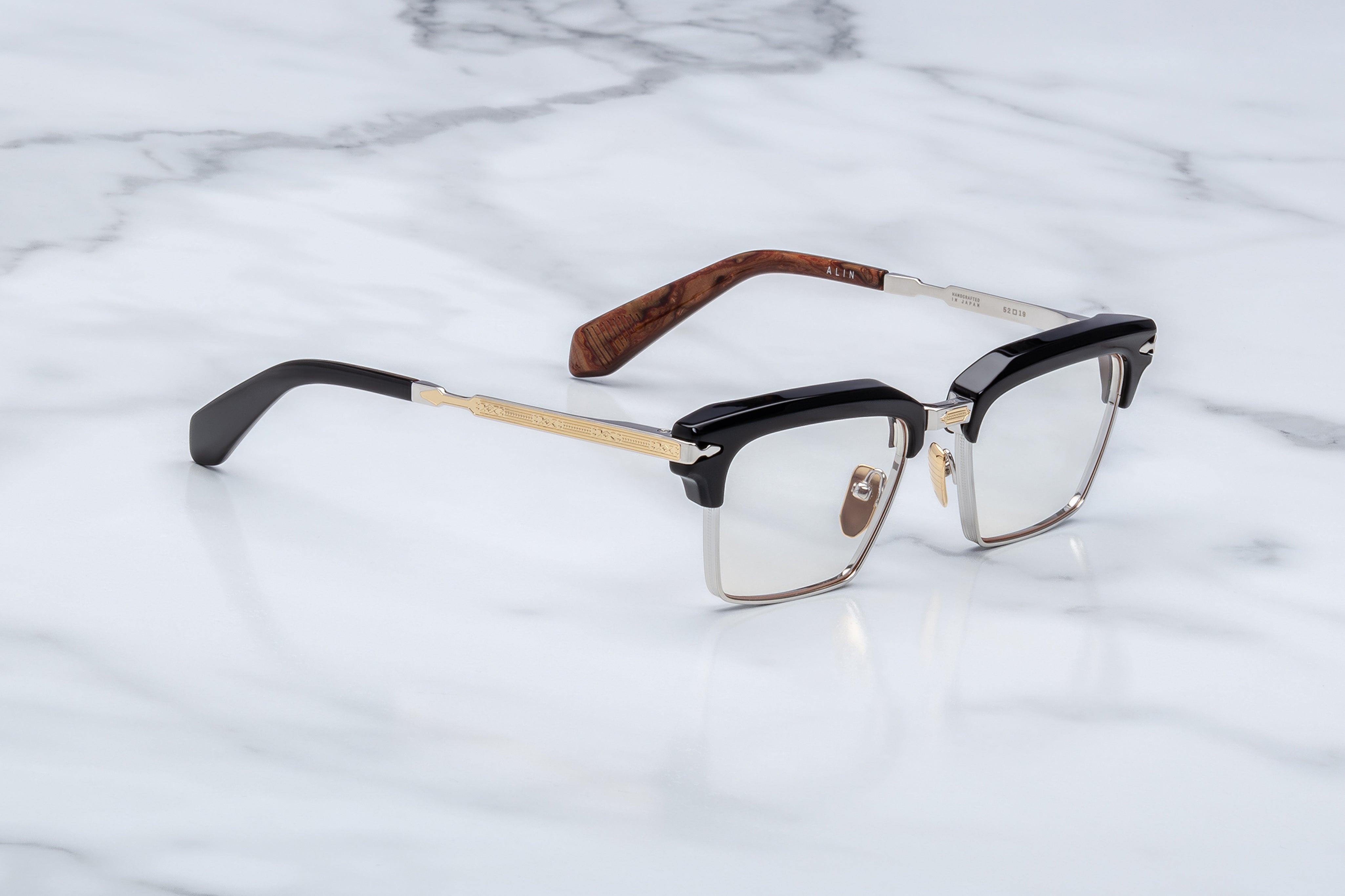 JMM alin noirx side view, black acetate top rim and ilver bottom rim. gold and silver temples 