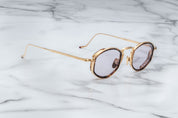 side view JMM Aragon oval shaped gold frames with innfer tortishell rim and key hold bridge