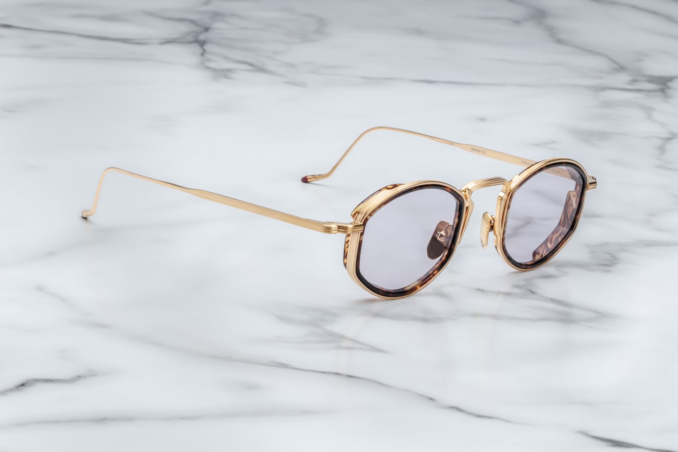 side view JMM Aragon oval shaped gold frames with innfer tortishell rim and key hold bridge