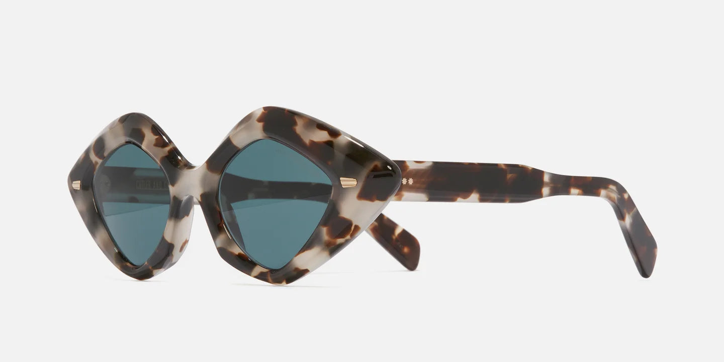 Sunglasses with tortoiseshell frame and blue lenses on a white background