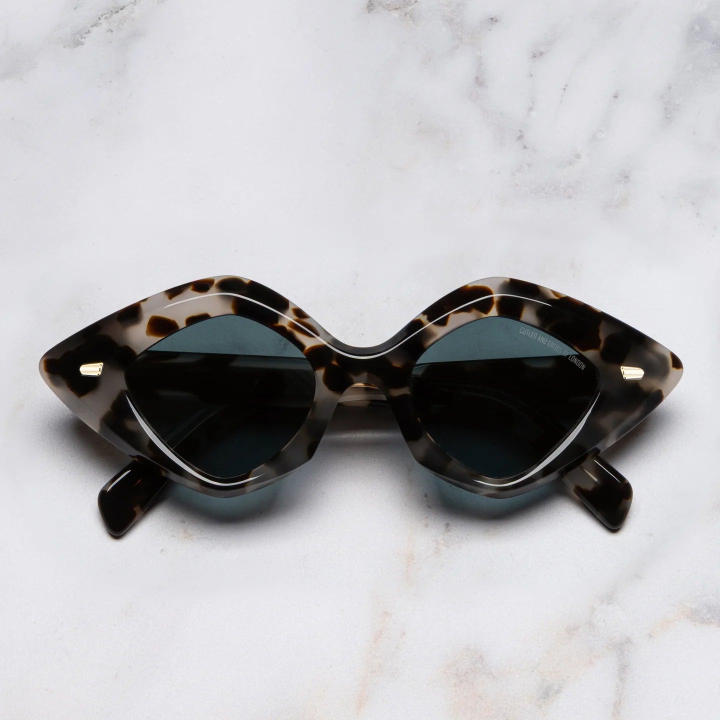 Sunglasses with tortoiseshell frame on a marble background