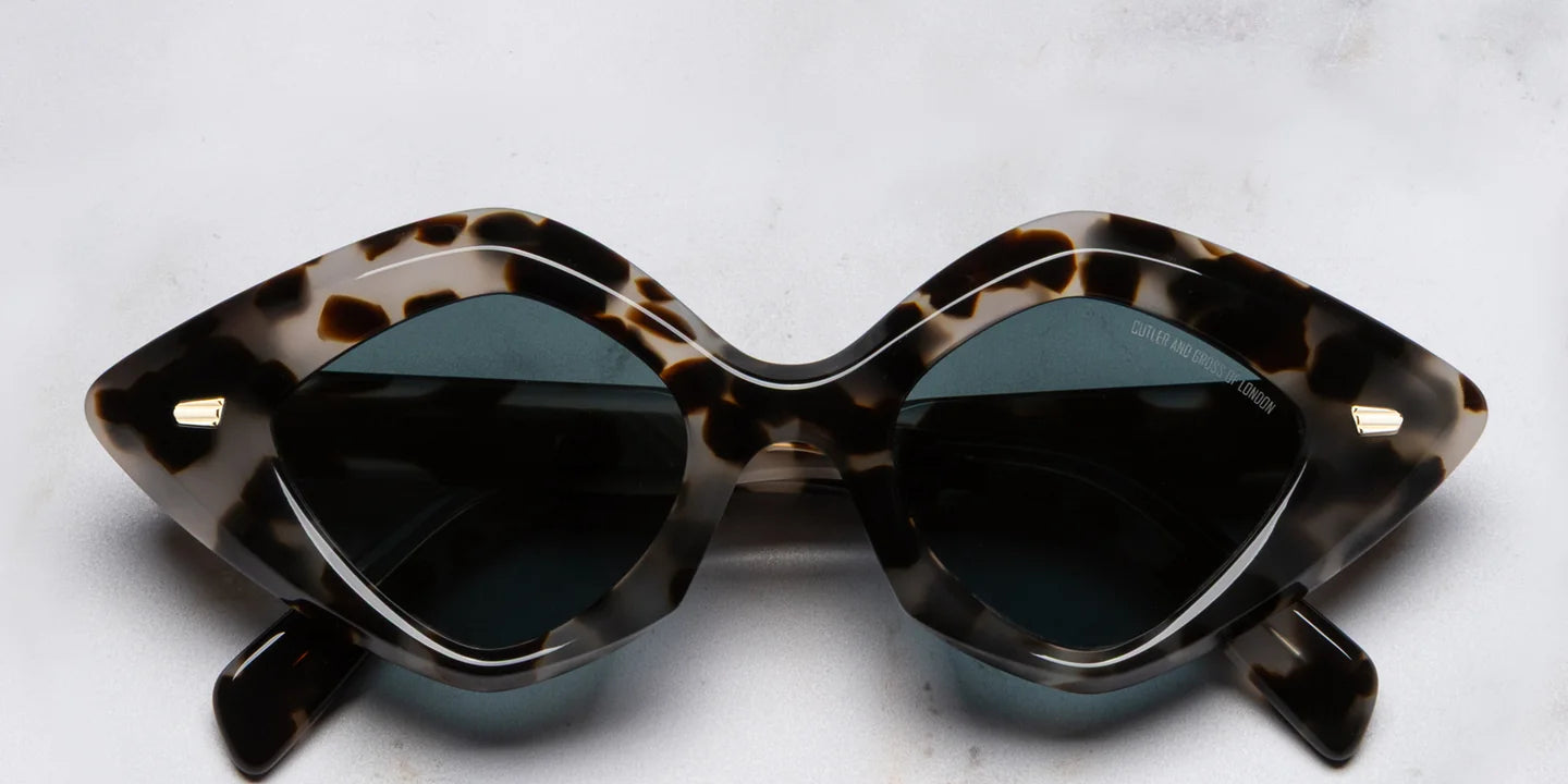 Sunglasses with tortoiseshell frame on a marble background