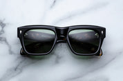 Black sunglasses on a marble surface