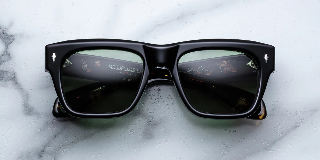 Black sunglasses on a marble surface