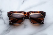 Sunglasses with tortoiseshell frame on a marble surface
