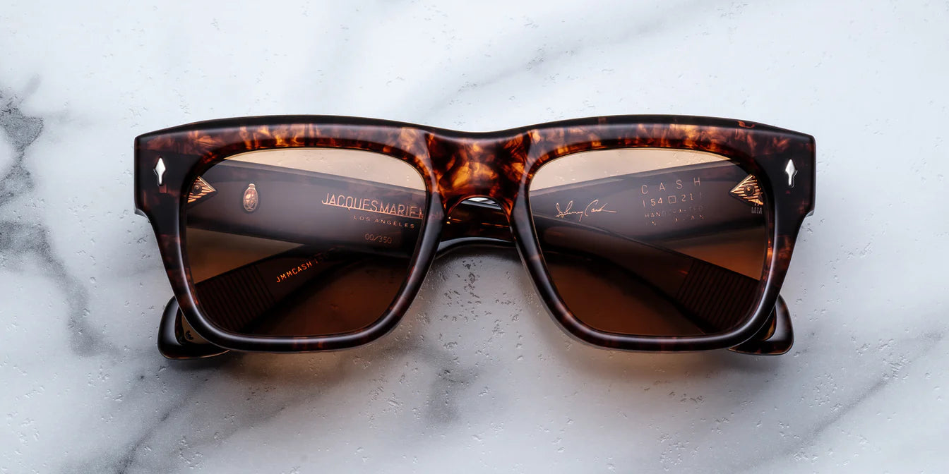 Sunglasses with tortoiseshell frame on a marble surface