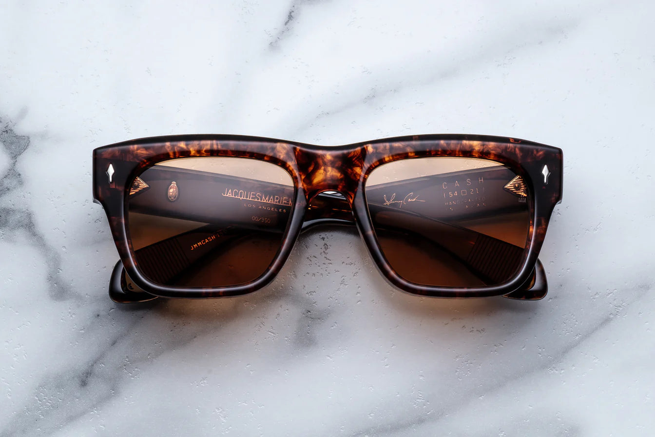 Sunglasses with tortoiseshell frame on a marble surface
