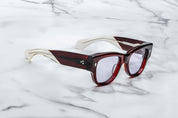 Deep red shell sunglass with sterling silver arrow head pin on the sides blue  side view