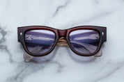 Deep red shell sunglass with sterling silver arrow head pin on the sides blue lenses 