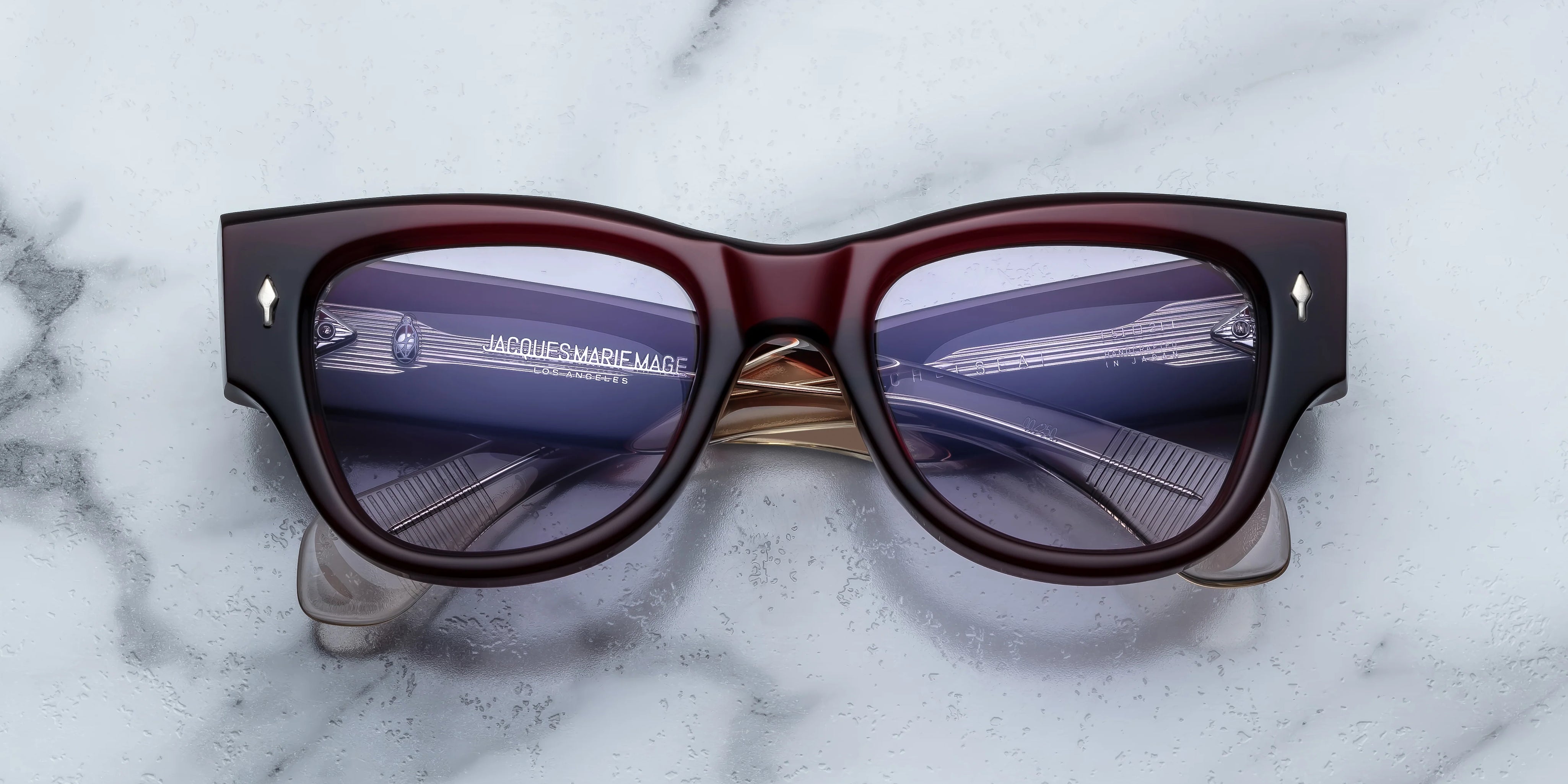 Deep red shell sunglass with sterling silver arrow head pin on the sides blue lenses 