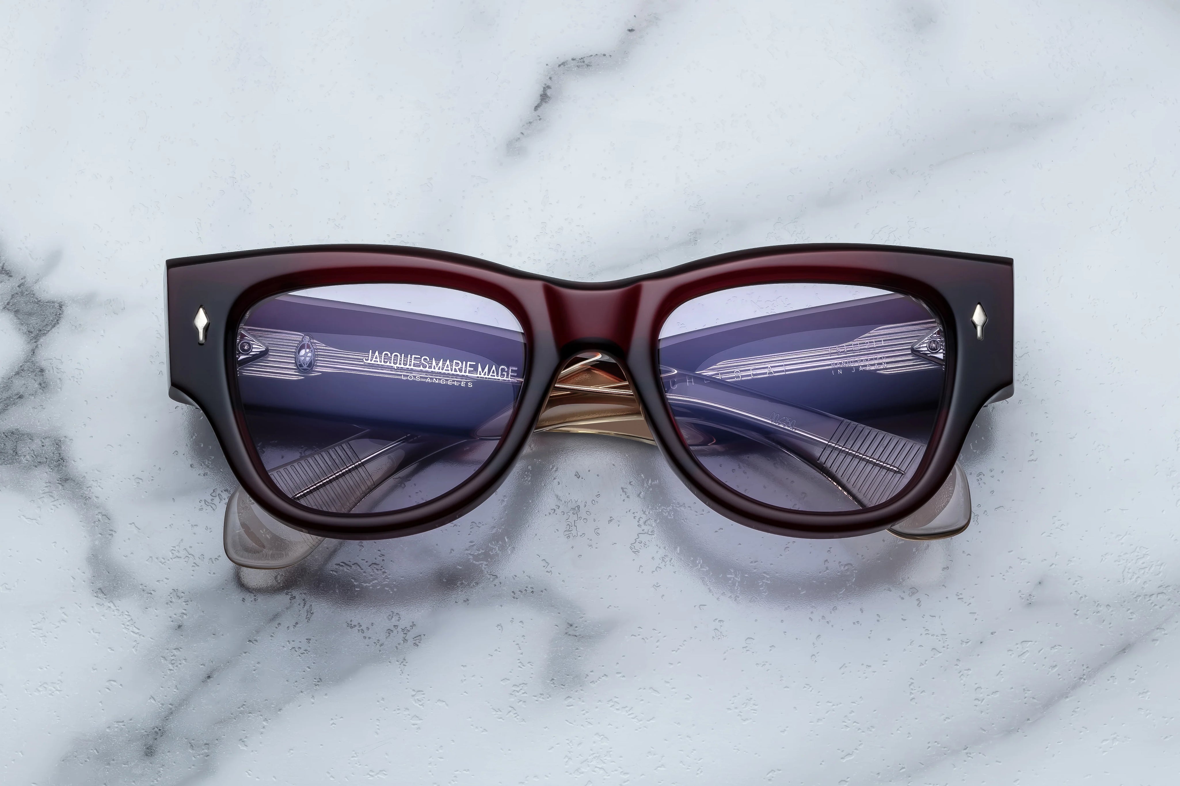 Deep red shell sunglass with sterling silver arrow head pin on the sides blue lenses 