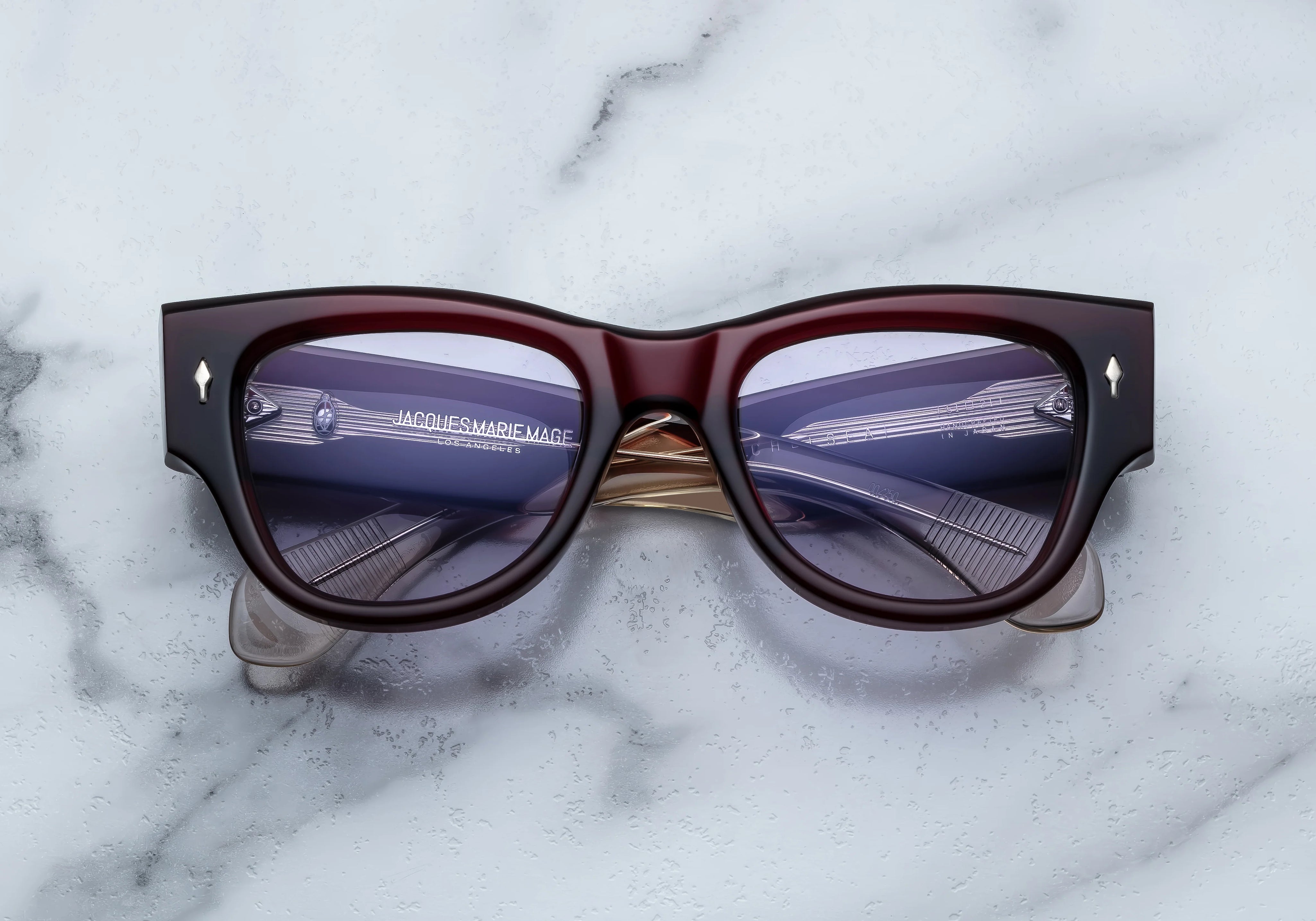 Deep red shell sunglass with sterling silver arrow head pin on the sides blue lenses 
