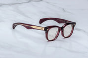 Side view of JM Hortense a Burgundy square frame with rounded edgesand gold detail on temples