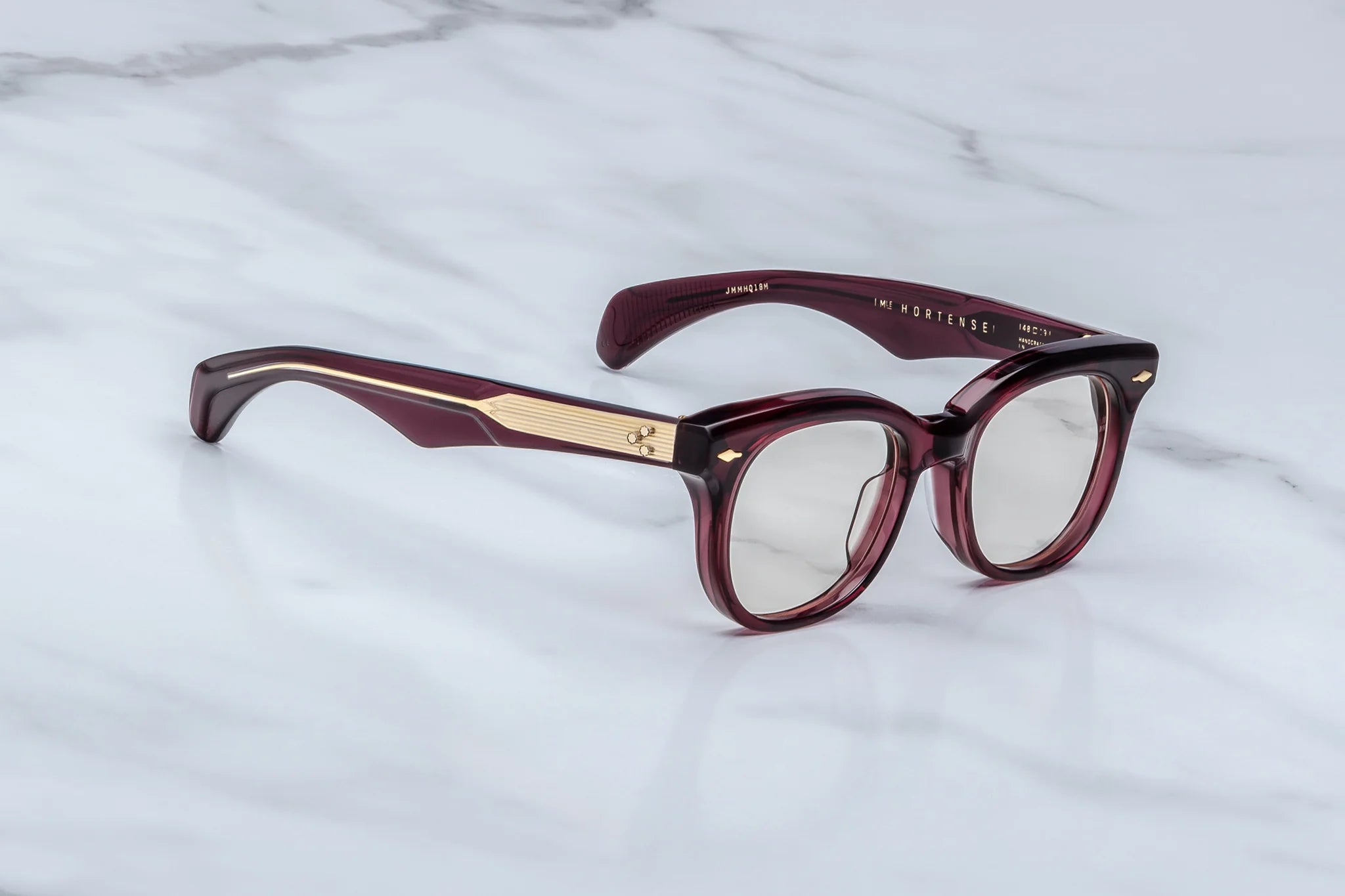Side view of JM Hortense a Burgundy square frame with rounded edgesand gold detail on temples