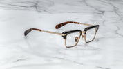 JMM Alin dark havana with acetate top rim and metal bottom rim wiht overlying acetate on the top side view