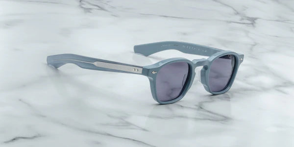 A pair of sunglasses with a distinctive frame, sculptural temples, and a sophisticated silhouette. The frame is notable for its slim lines. side on view