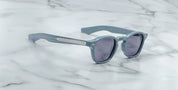 A pair of sunglasses with a distinctive frame, sculptural temples, and a sophisticated silhouette. The frame is notable for its slim lines. side on view