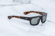 Side view of rectangu;ar sunglass with torishell temples at the tips