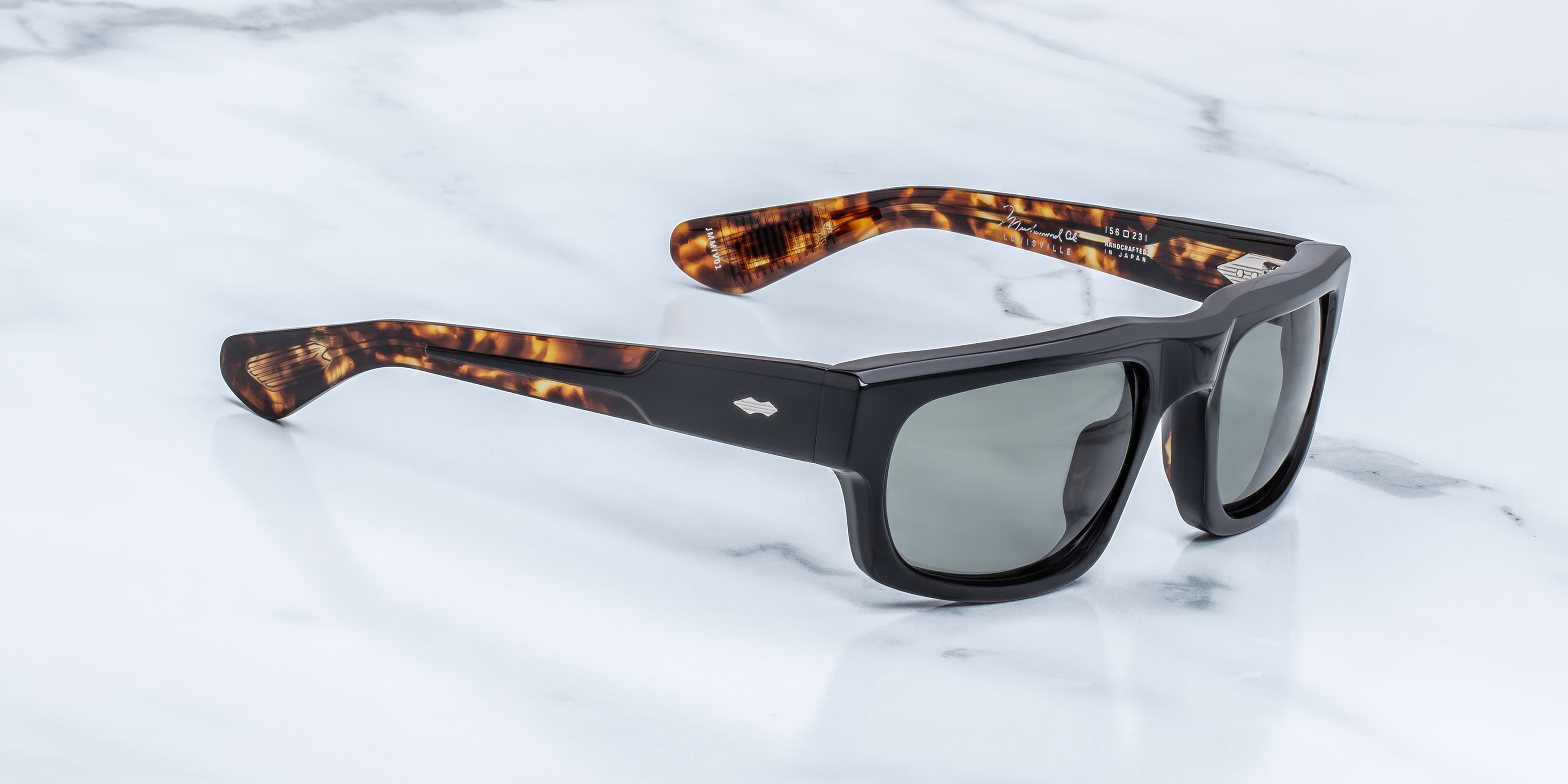 Side view of rectangu;ar sunglass with torishell temples at the tips