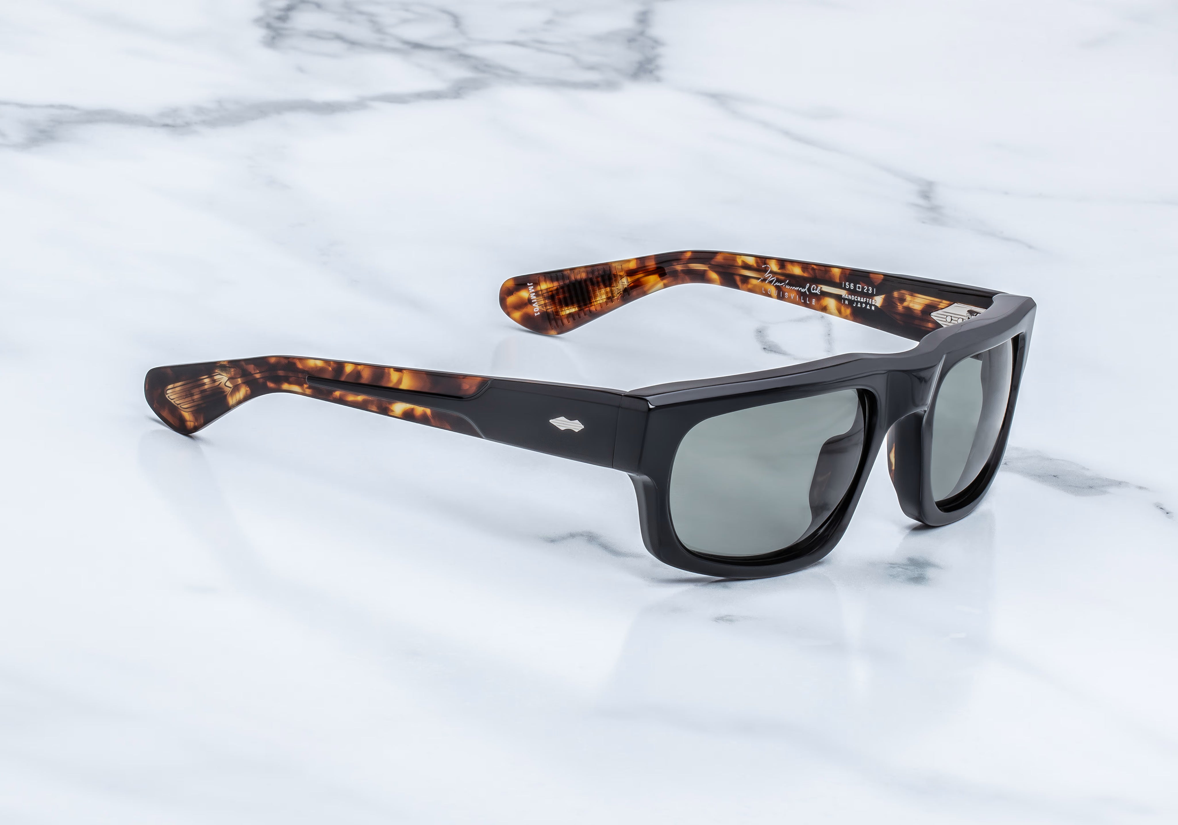 Side view of rectangu;ar sunglass with torishell temples at the tips