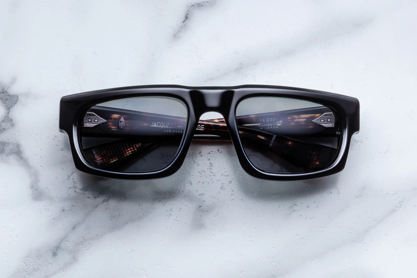 black regctangular sunglass frame with tortishell on the inner temples