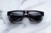 black regctangular sunglass frame with tortishell on the inner temples