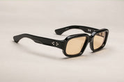 A pair of black rectangular eyeglasses with a modest wrap-around effect, featuring exposed wirecore temples. side view