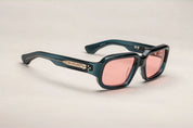 A pair of indigo rectangular eyeglasses with a modest wrap-around effect, featuring exposed wirecore temples.