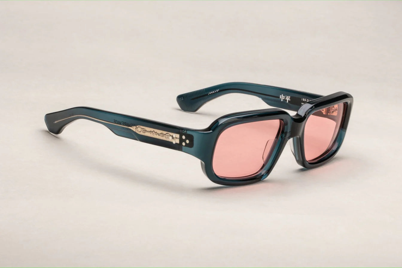 A pair of indigo rectangular eyeglasses with a modest wrap-around effect, featuring exposed wirecore temples.