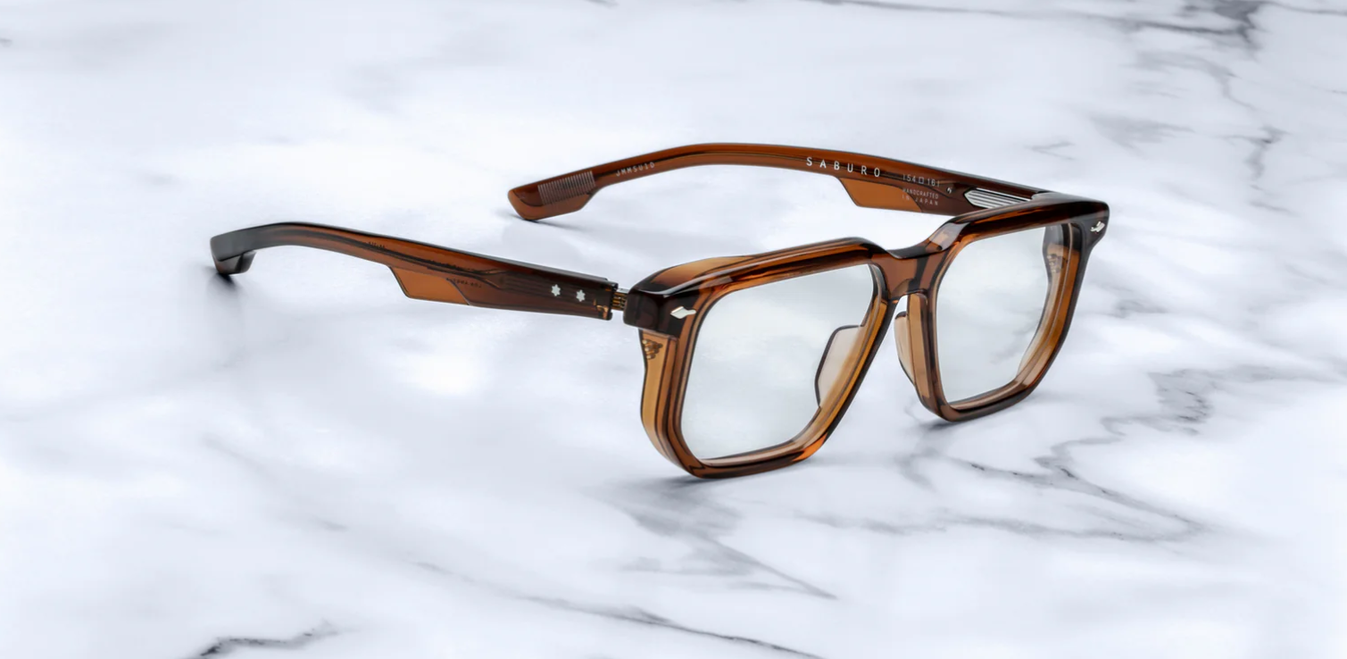 A pair of Jacques Marie Mage Saburo optical frames with a hickory color and navigator-style design, featuring handcrafted acetate and signature floating hinges. side view