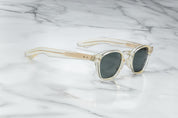 A pair of sunglasses with a distinctive frame, sculptural temples, and a sophisticated silhouette. The frame is notable for its slim lines in champgne side on view