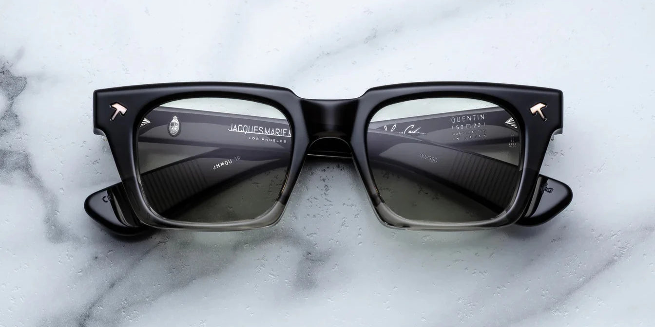 black fade sunglass front on with silver hammer detail on the corners and blue lenses