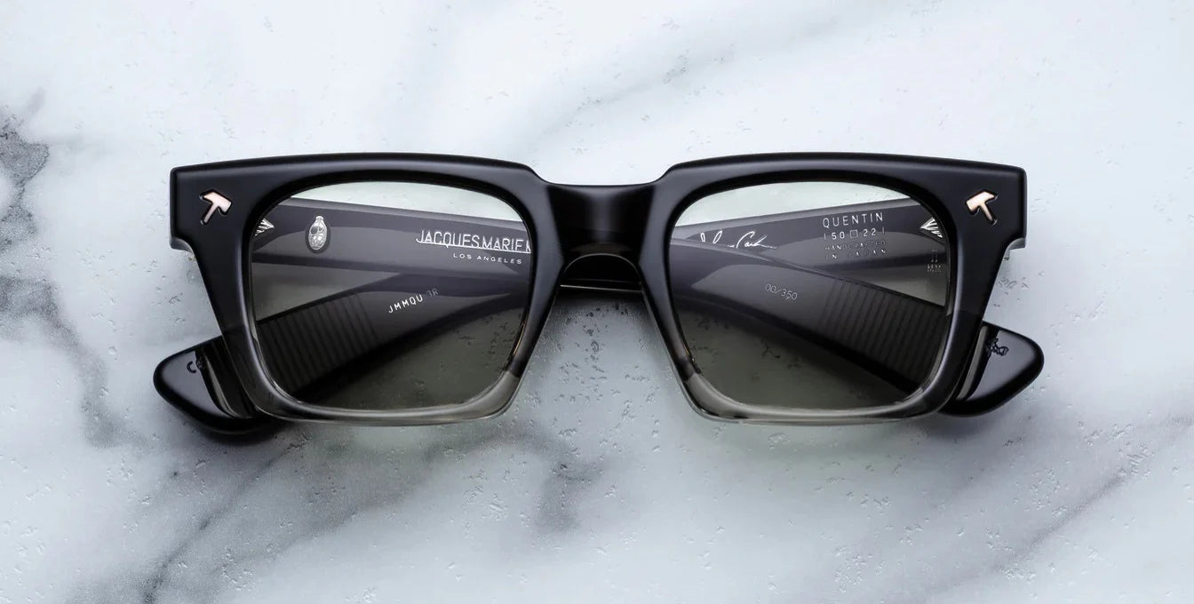 black fade sunglass front on with silver hammer detail on the corners and blue lenses