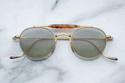 Gold metal aviator style sunglass with double bridge and acetate finish at the top 
