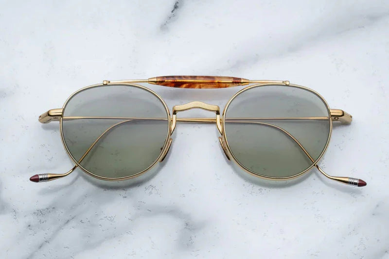 Gold metal aviator style sunglass with double bridge and acetate finish at the top 