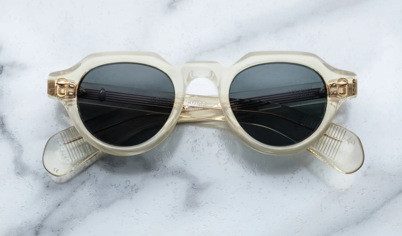 A pair of Jacques Marie Mage sunglasses with a modified Panto-shape, featuring a precious metal arrowhead front, spur-shaped rivets, and custom 7-barrel hinges.
