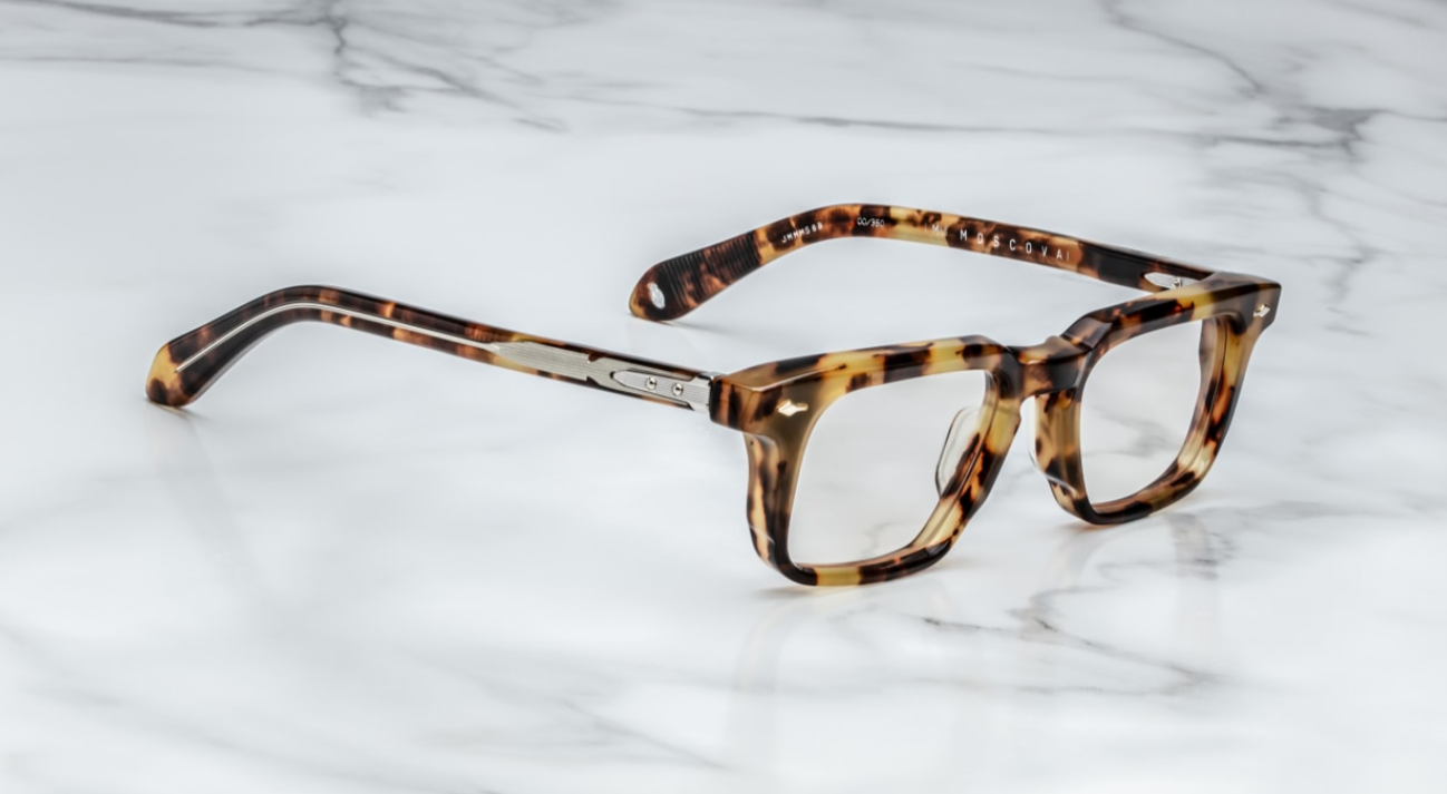A pair of Jacques Marie Mage eyeglasses with a strong rectangular lens shape, titanium hinges, and wirecore temples with engraved details, in a Havana style pattern. side view