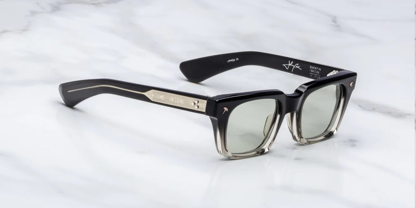 side on view of black fade sunglasses with silver detail on temples