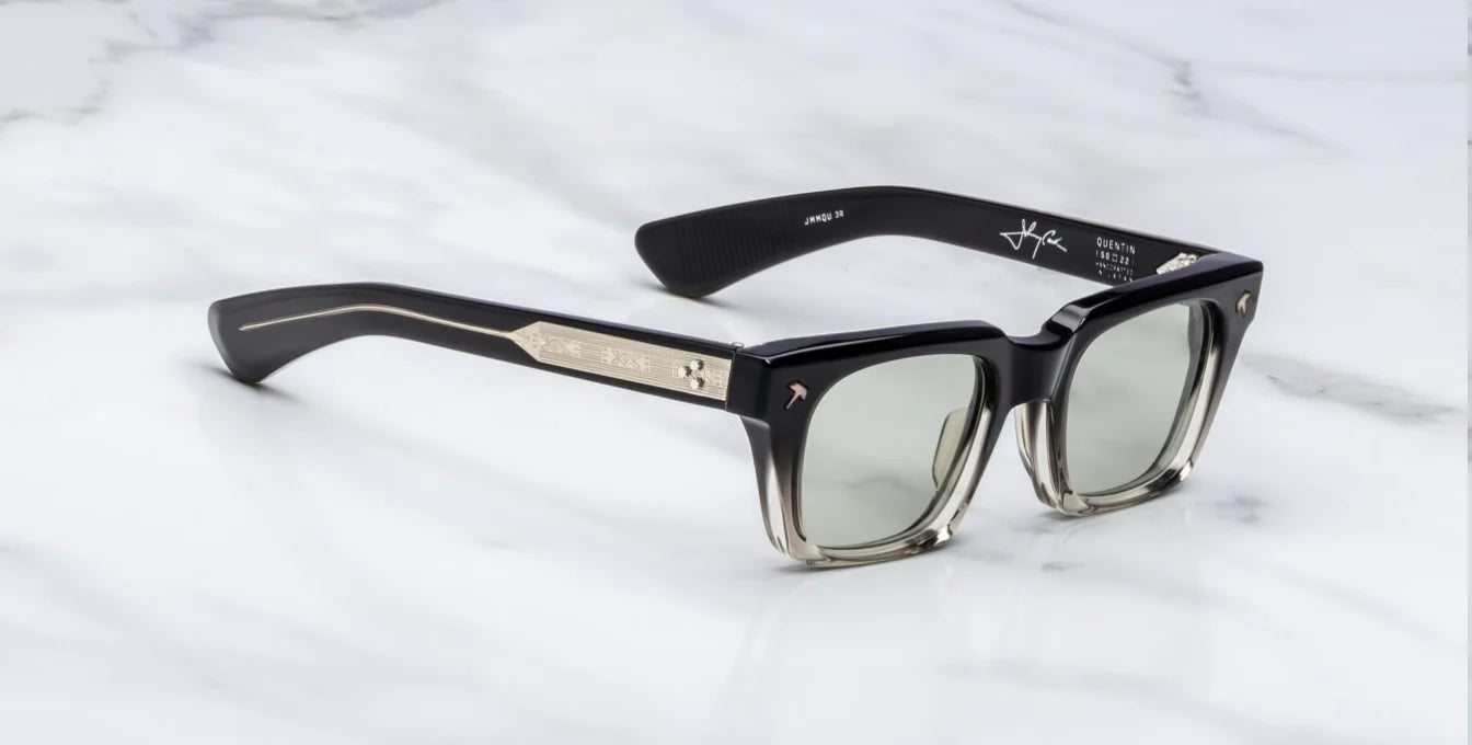 side on view of black fade sunglasses with silver detail on temples