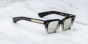 side on view of black fade sunglasses with silver detail on temples